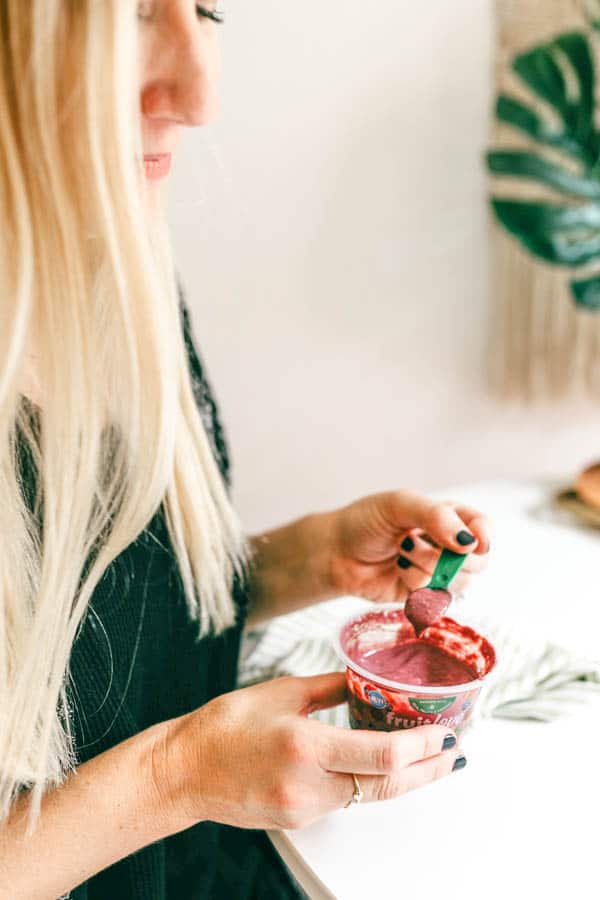 woman eating Fruitlove as a healthier snack option.