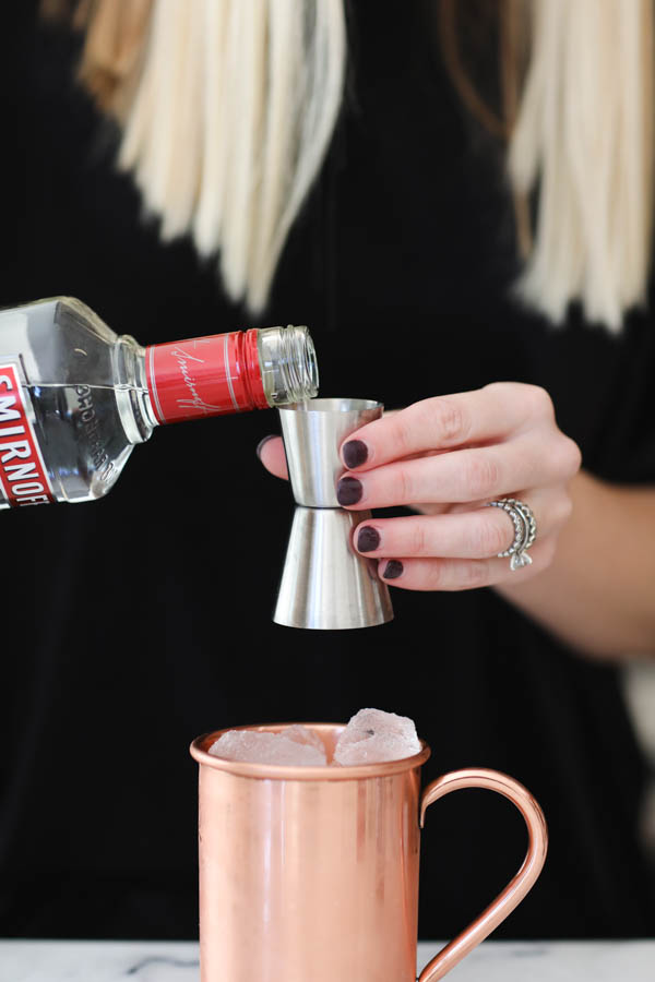 Adding vodka to a pear moscow mule.