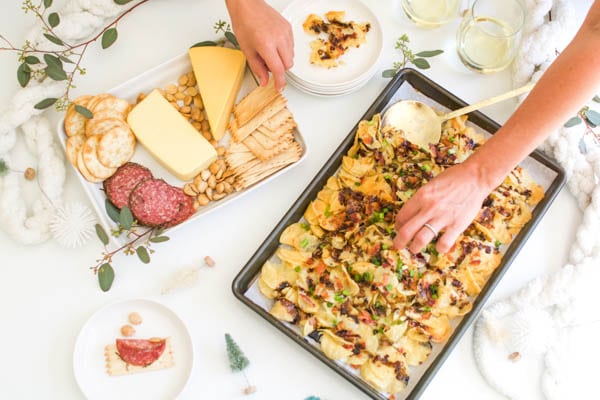 Potato Chip Nachos on a tray next to a cheese plate for easy party snacks.