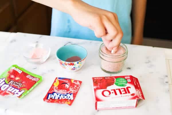 A kid tasting the homemade Fun Dip candy options. 