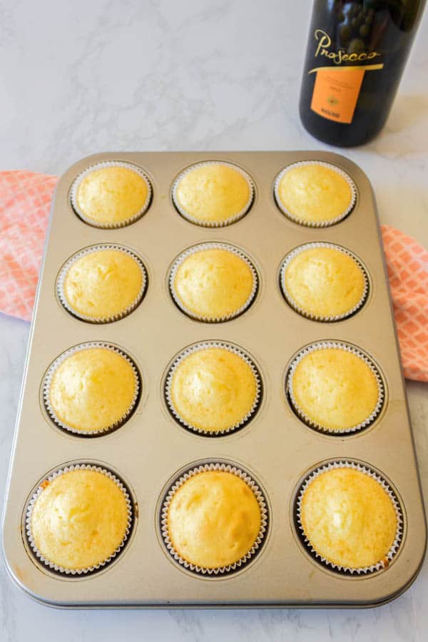 Baked Prosecco cupcakes in a cupcake pan without frosting.