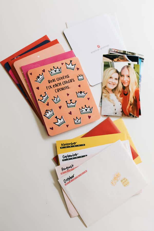 Stacks of greeting cards and photos on a white surface.