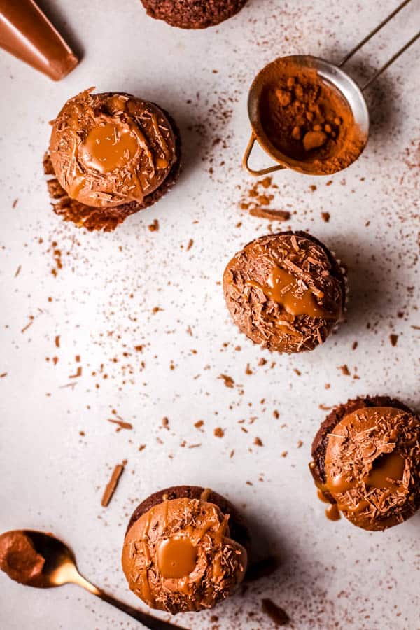 Overhead view of frosting chocolate cupcakes.