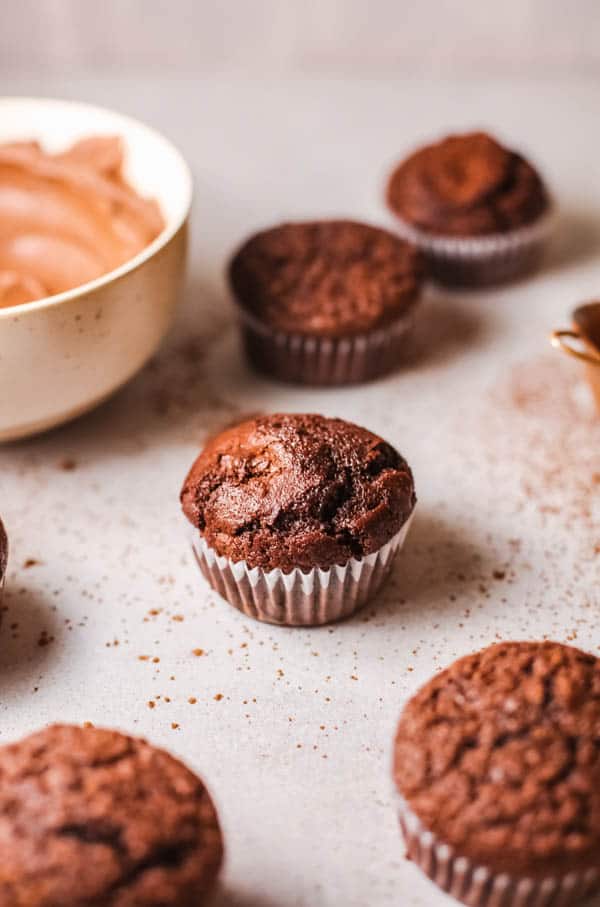 Close up of an unfrosted chocolate cupcakes on a table.