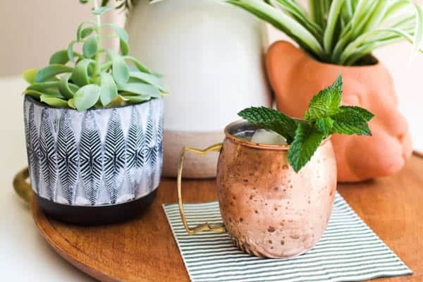 Rum Mule recipe in a copper mug with fresh mint garnish on a table.