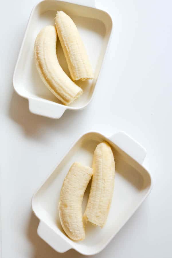 Over ripe bananas in baking dishes before they are oven roasted.