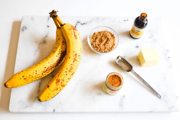 Ingredients for easy baked bananas on a marble cutting board.