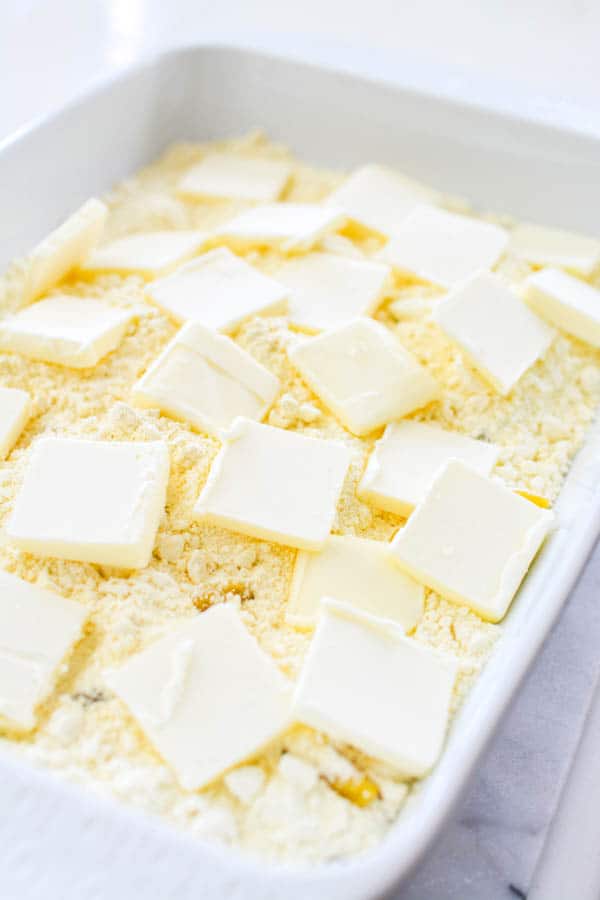 Peaches, butter and dry cake mix in baking pan.