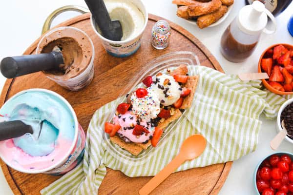 An ice cream sundae bar on a table.