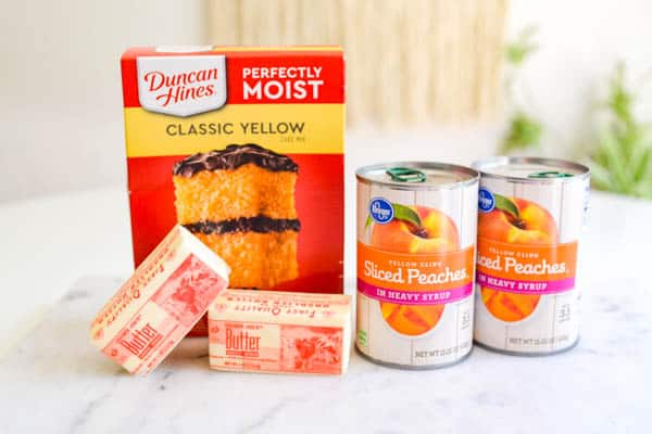 Ingredients for peach dump cake on a cutting board.