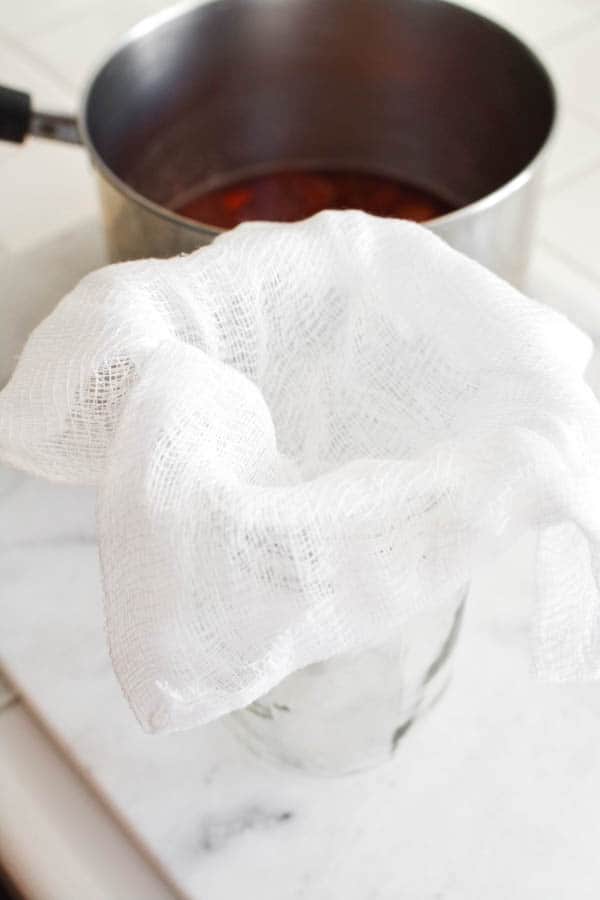 Cheese cloth in a jar to strain strawberry syrup.