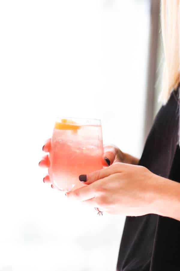 Rosé Lemonade Spritzer in woman's hands. 