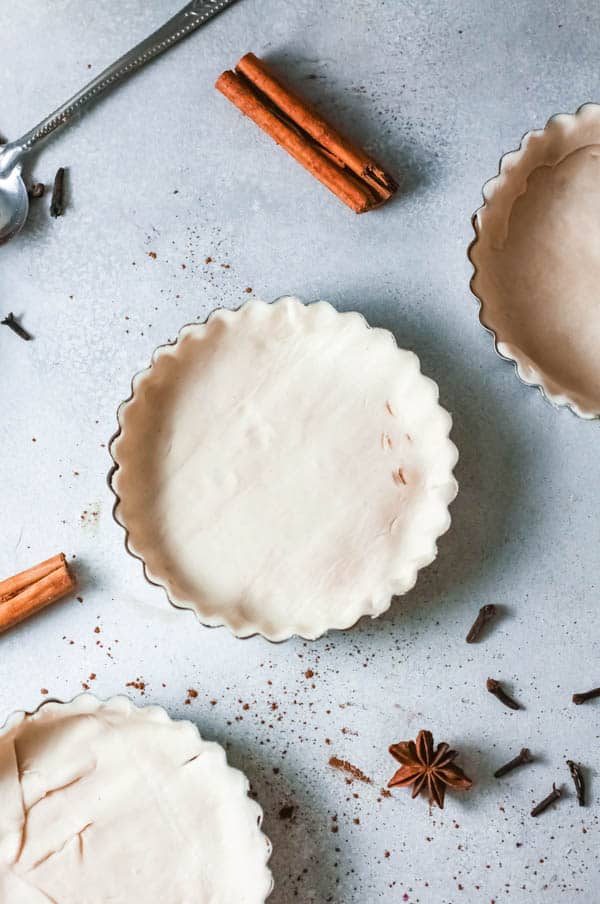 Top view of a mini pie shells with crusts on a tables.