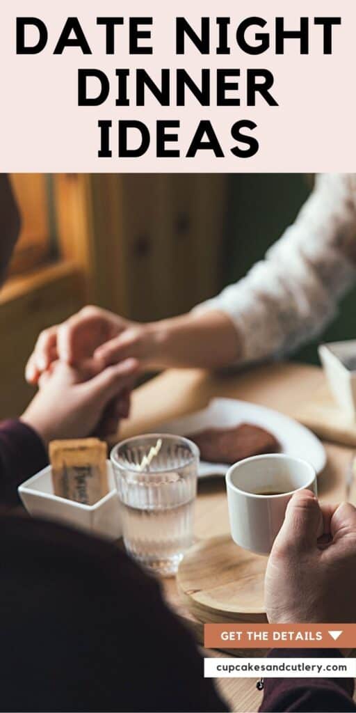 A man and woman holding hands over a table for a date night at home.