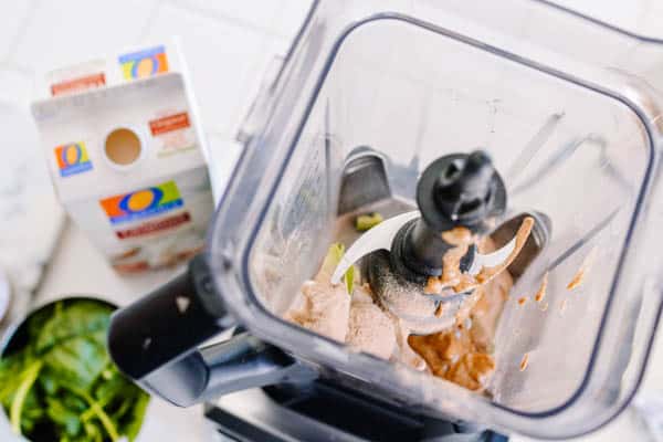 A view inside a blender with ingredients to make an avocado and banana smoothie