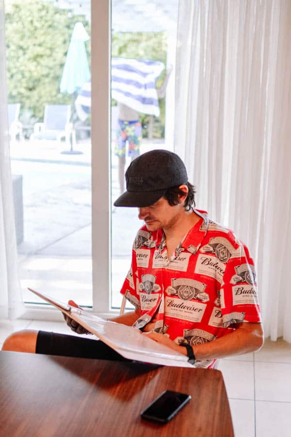 Man looking through the vacation rental binder of information.