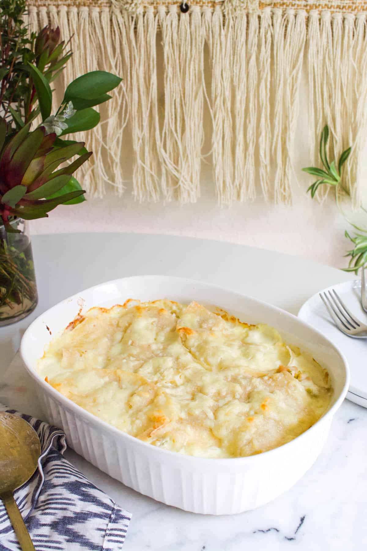 Baked Swiss Enchilada Casserole in a baking dish on a table.