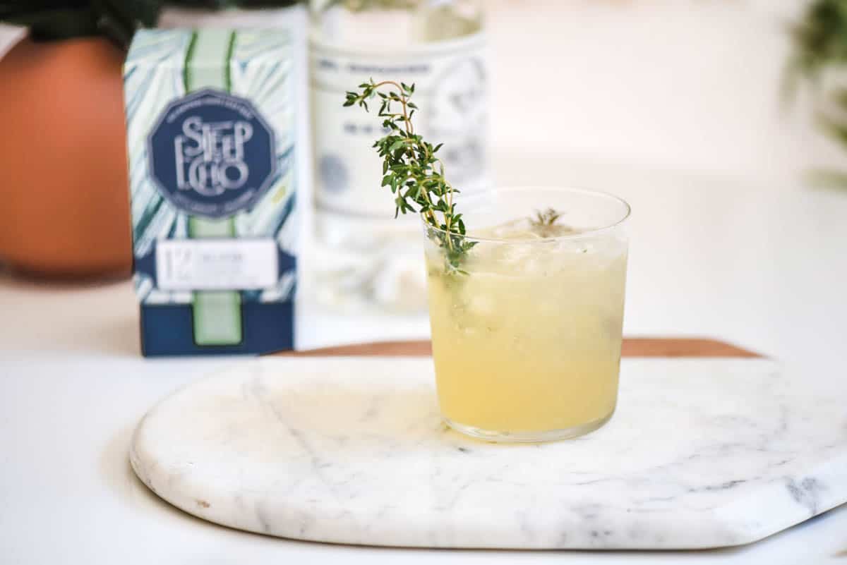 Gin and tea cocktail on a marble cutting board.