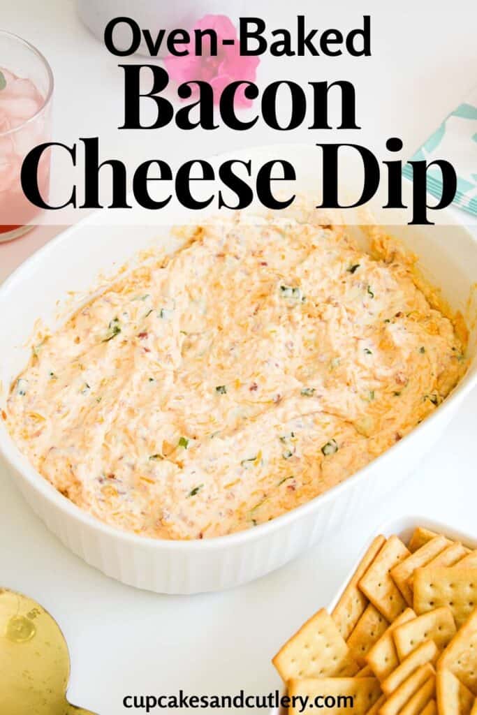 Close up of hot bacon cheese dip in a white baking dish on a table.