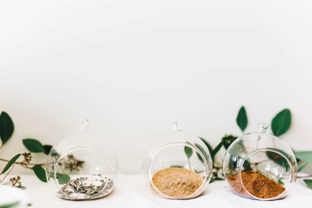 3 small bowls of flavored sugar on a table.