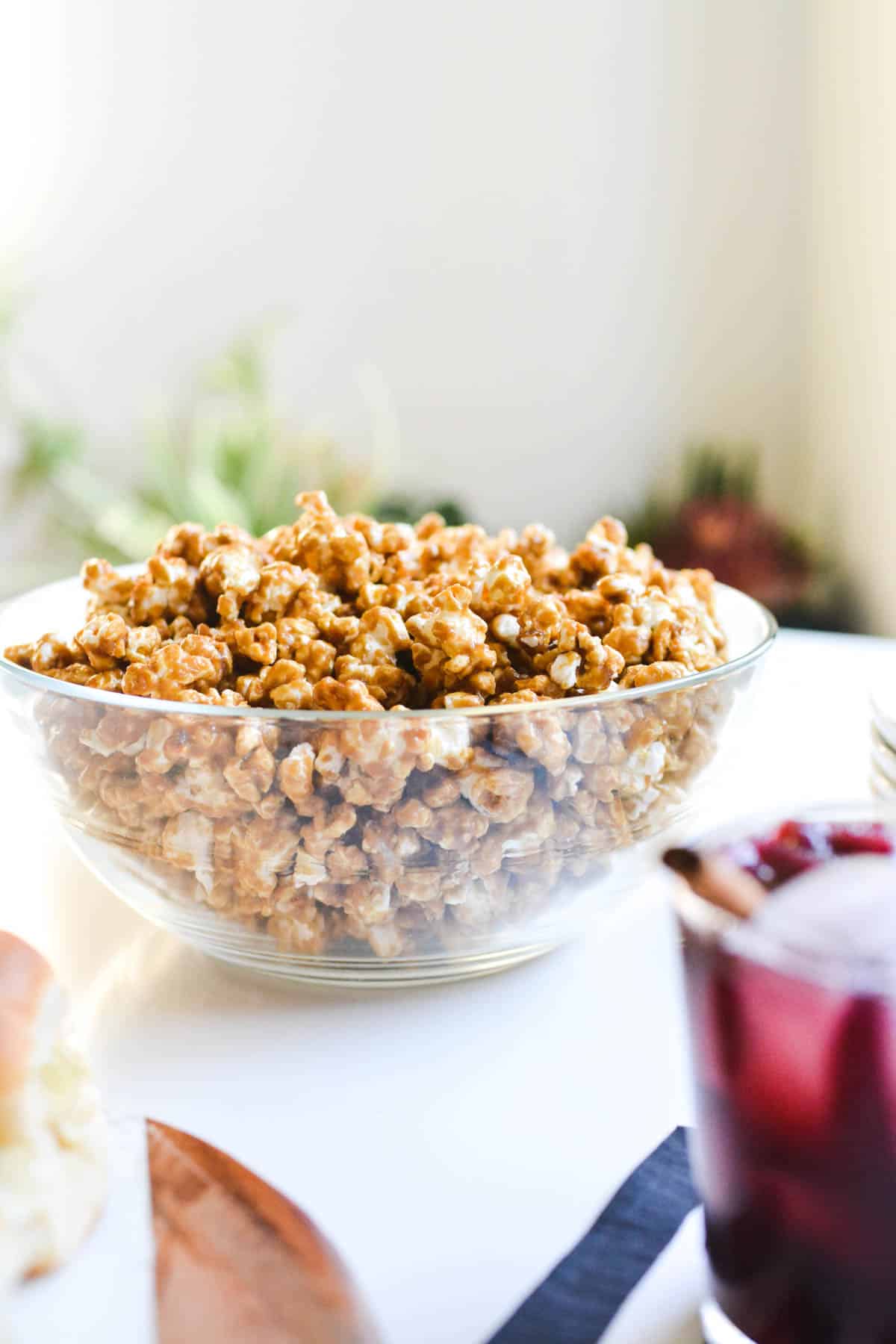 A bowl of caramel corn on a table.