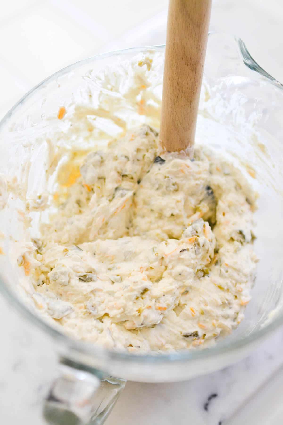 Mixing bowl with a cream cheese dip being made.