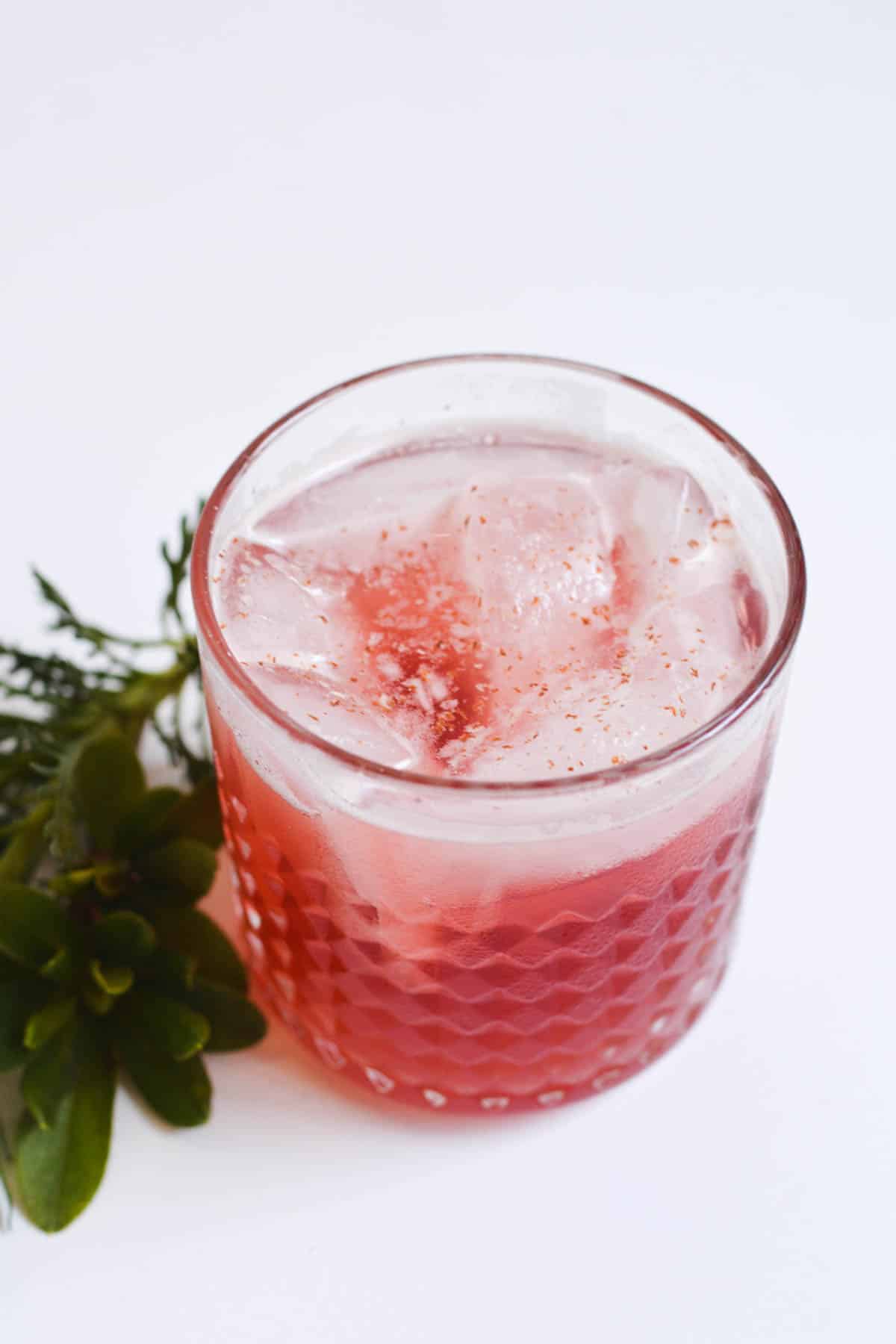 Close up of a bourbon Christmas cocktail on a table.