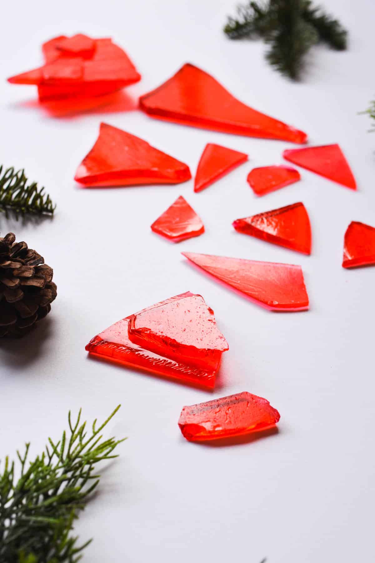 Pieces of red glass candy on a table.