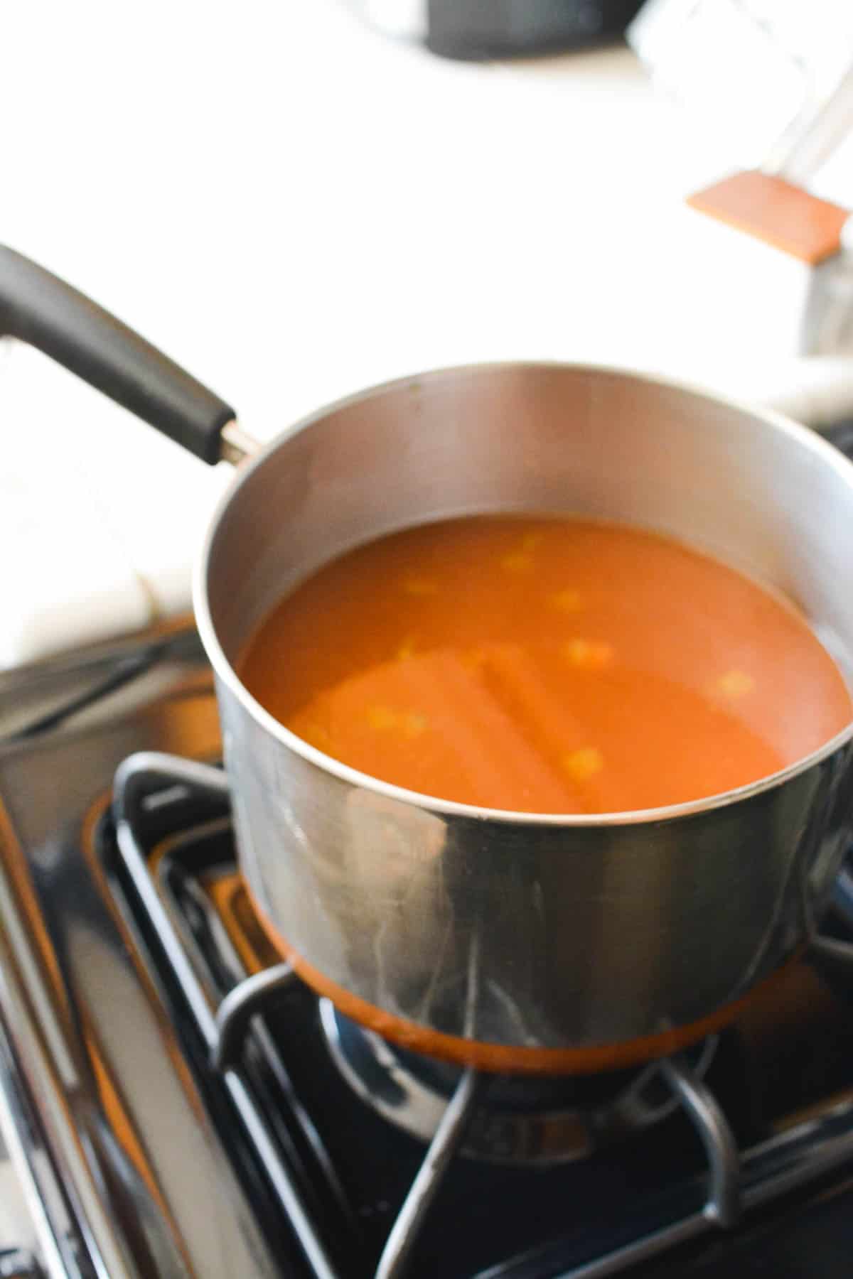 A pan full of tortilla soup on the stove.