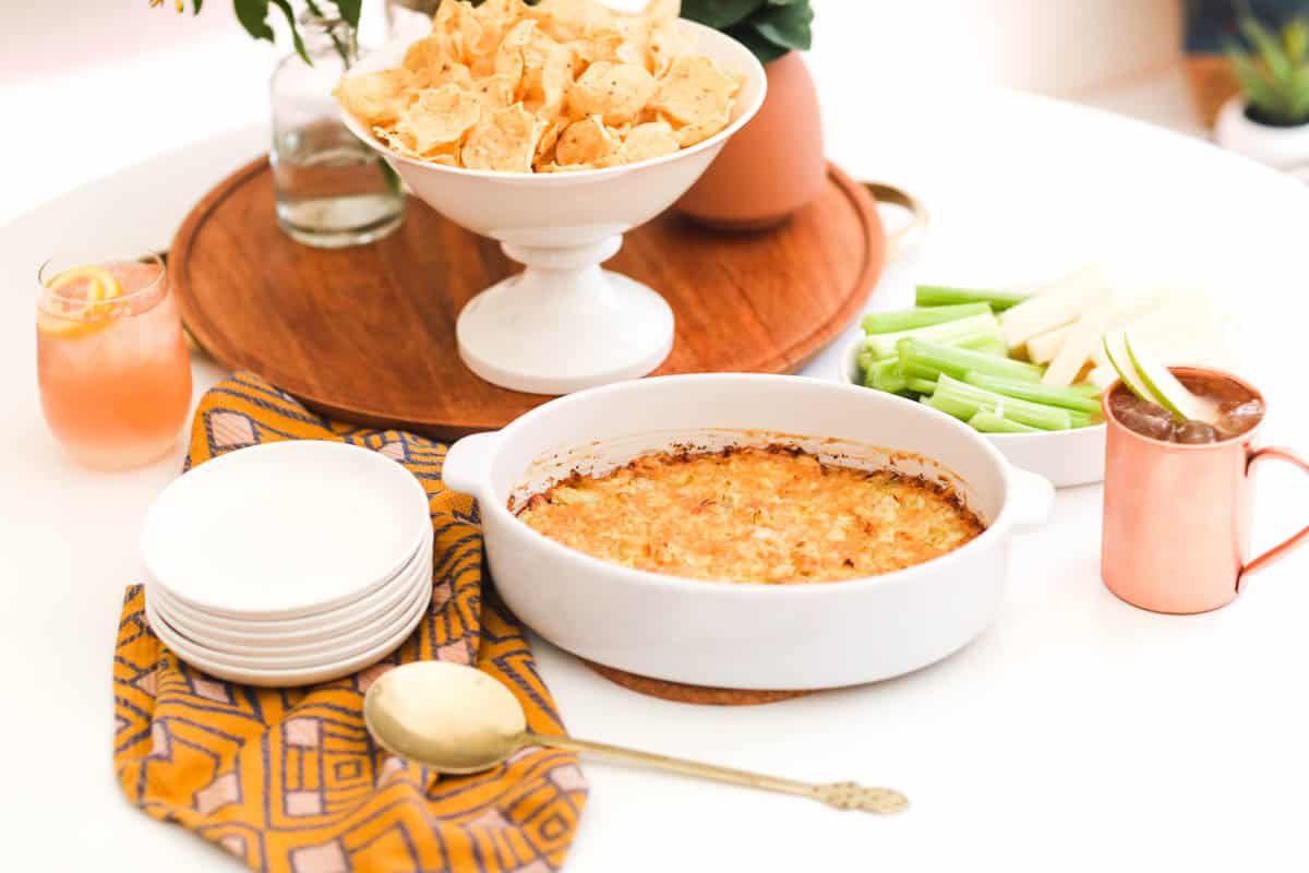 Baked hot artichoke dip on a party table.