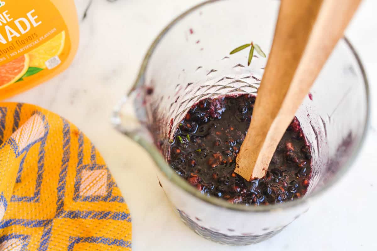 Overhead shot of bar pitcher with muddle blackberries.