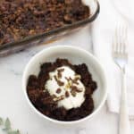 chocolate peppermint dump cake in a small white bowl on a counter.