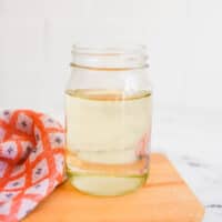 Close up of a jar holding simple syrup.