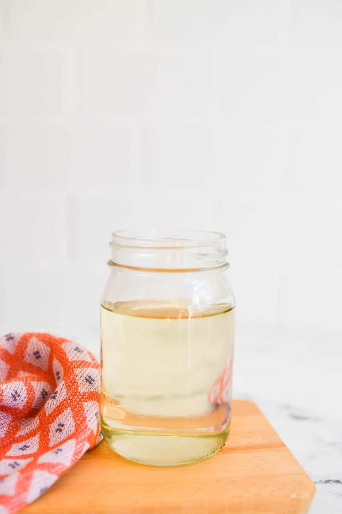 Simple syrup in a jar on a counter.