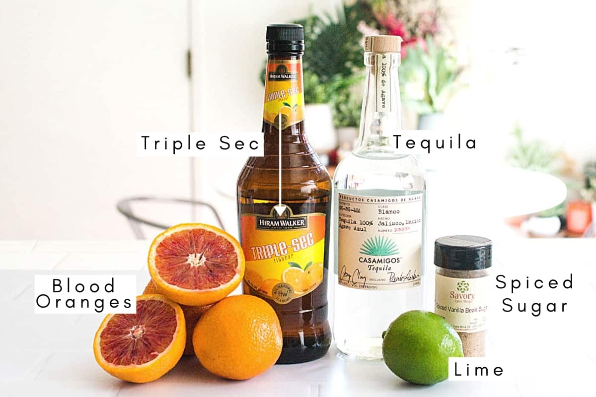 Labeled ingredients to make a blood orange margarita.