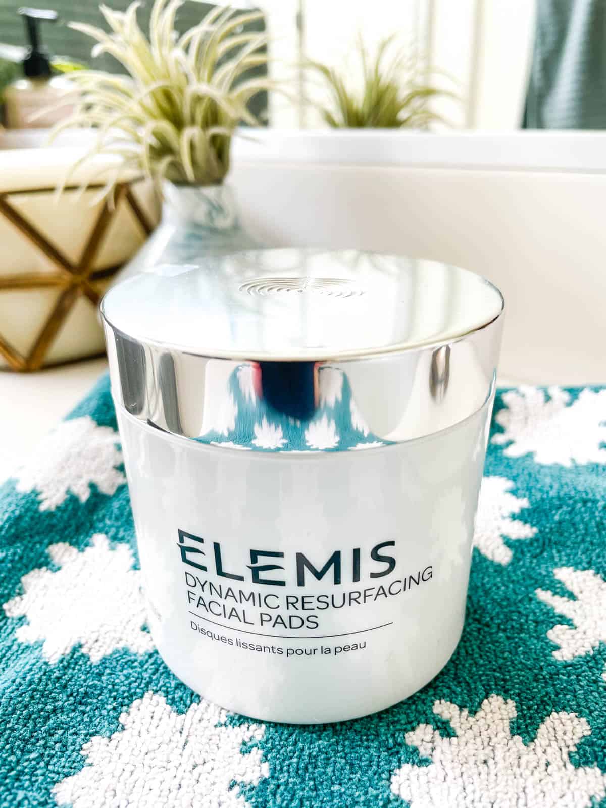 A jar of Elemis Dynamic Resurfacing Facial Pads on a towel.