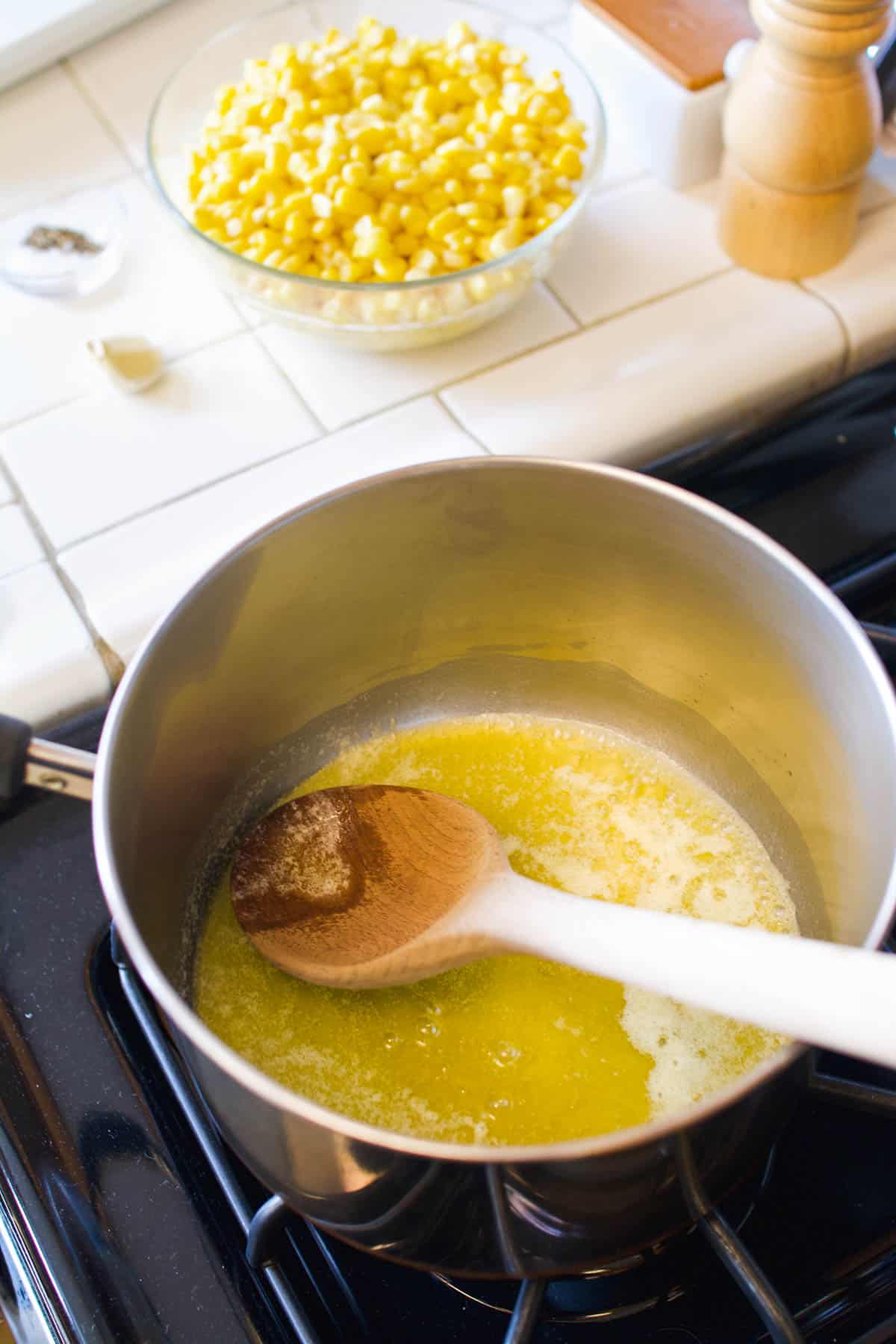 Brown butter in a sauce pan for a corn side dish recipe.