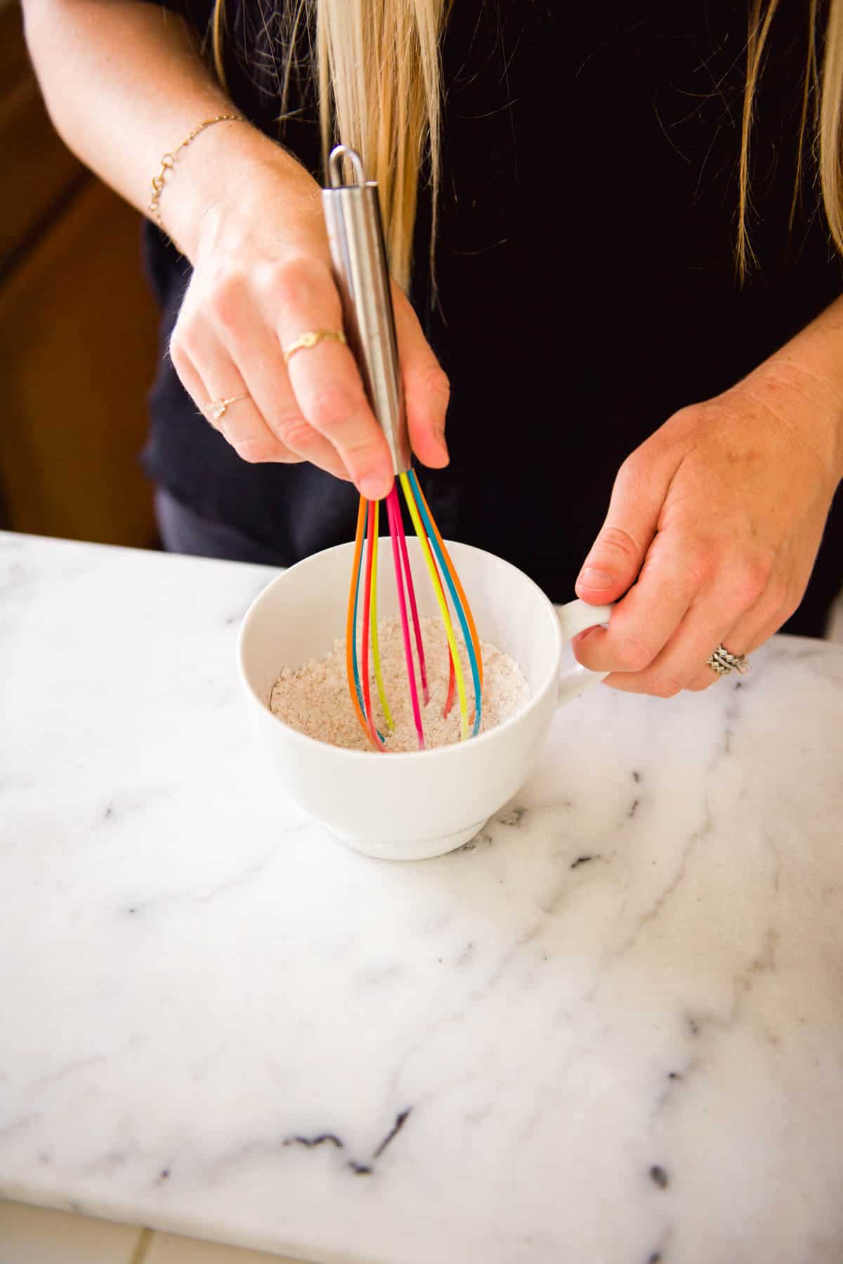 Whisking ingredients in a mug.