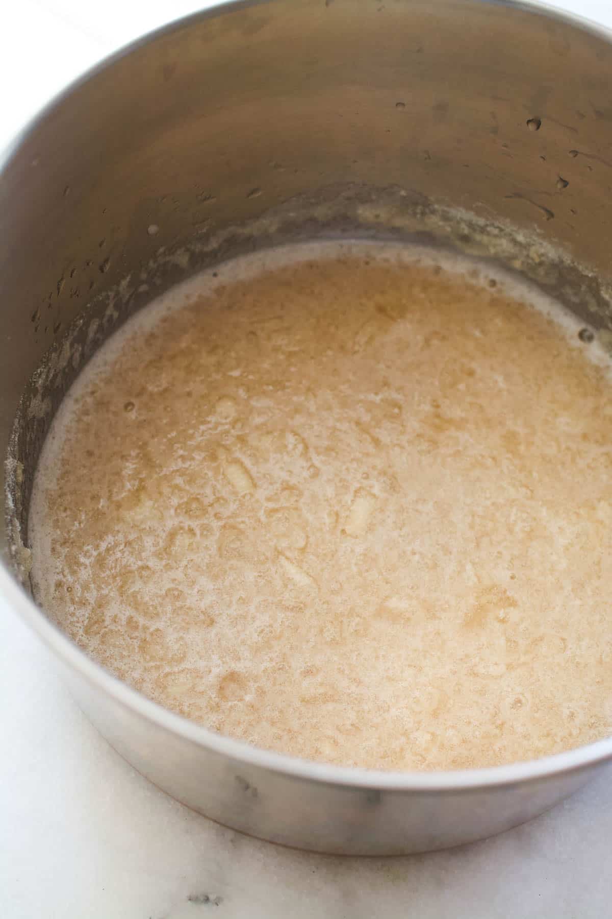 A sauce pan holding a gelatin mixture to make wine jello shots.