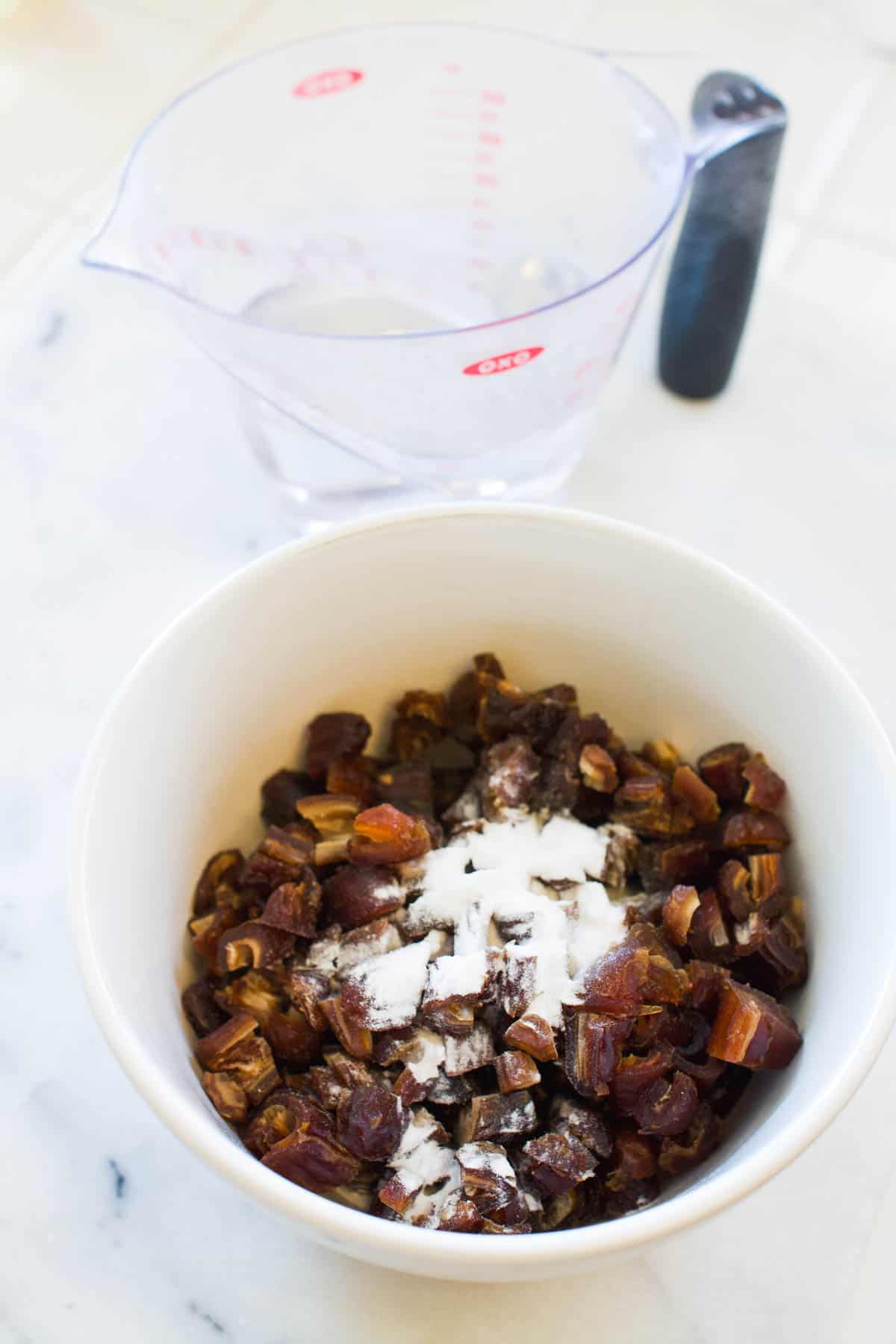 Chopped dates in a small bowl with baking powder.