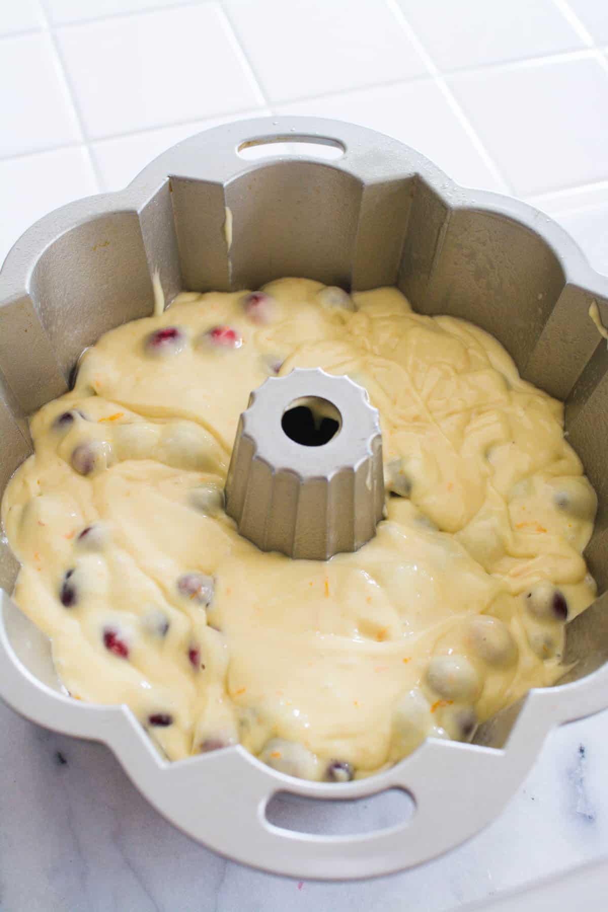 Cranberry cake batter in a bundt pan.