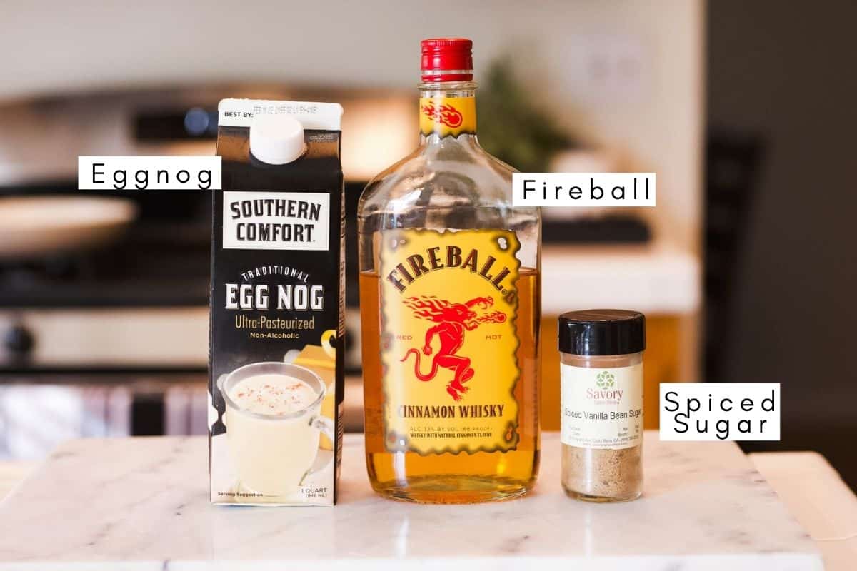 Labeled ingredients to make a cocktail with Fireball and Eggnog.