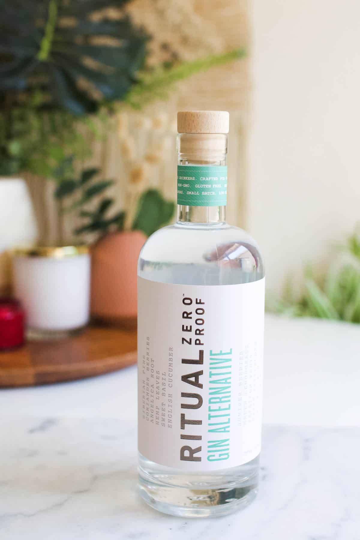 A bottle of zero proof gin on a table to drink during dry january.