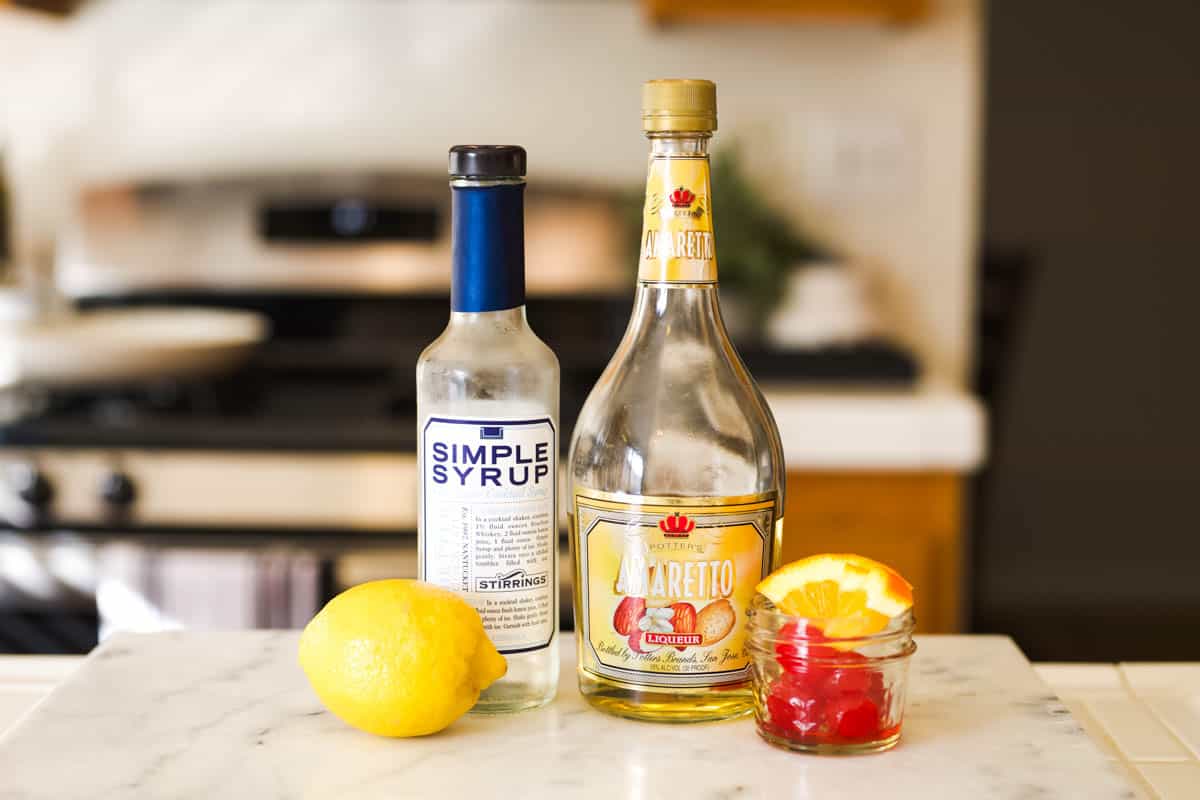 Ingredients to make an Amaretto Sour on a counter.