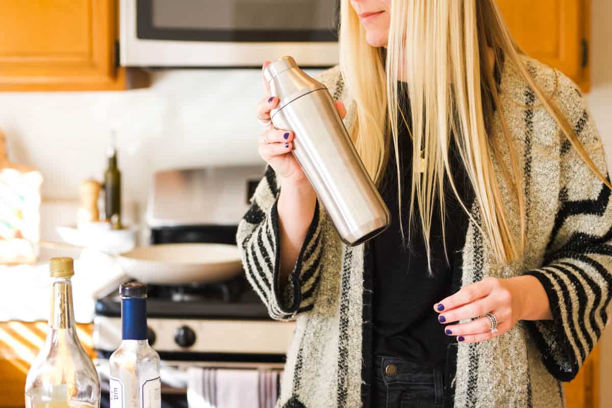 Woman holding a cocktail shaker.