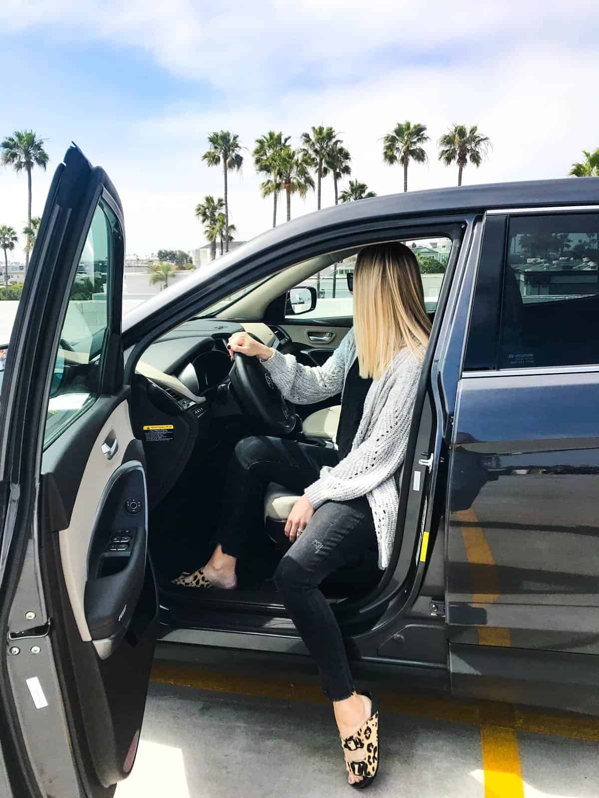 A mom waiting for the kids in the car.