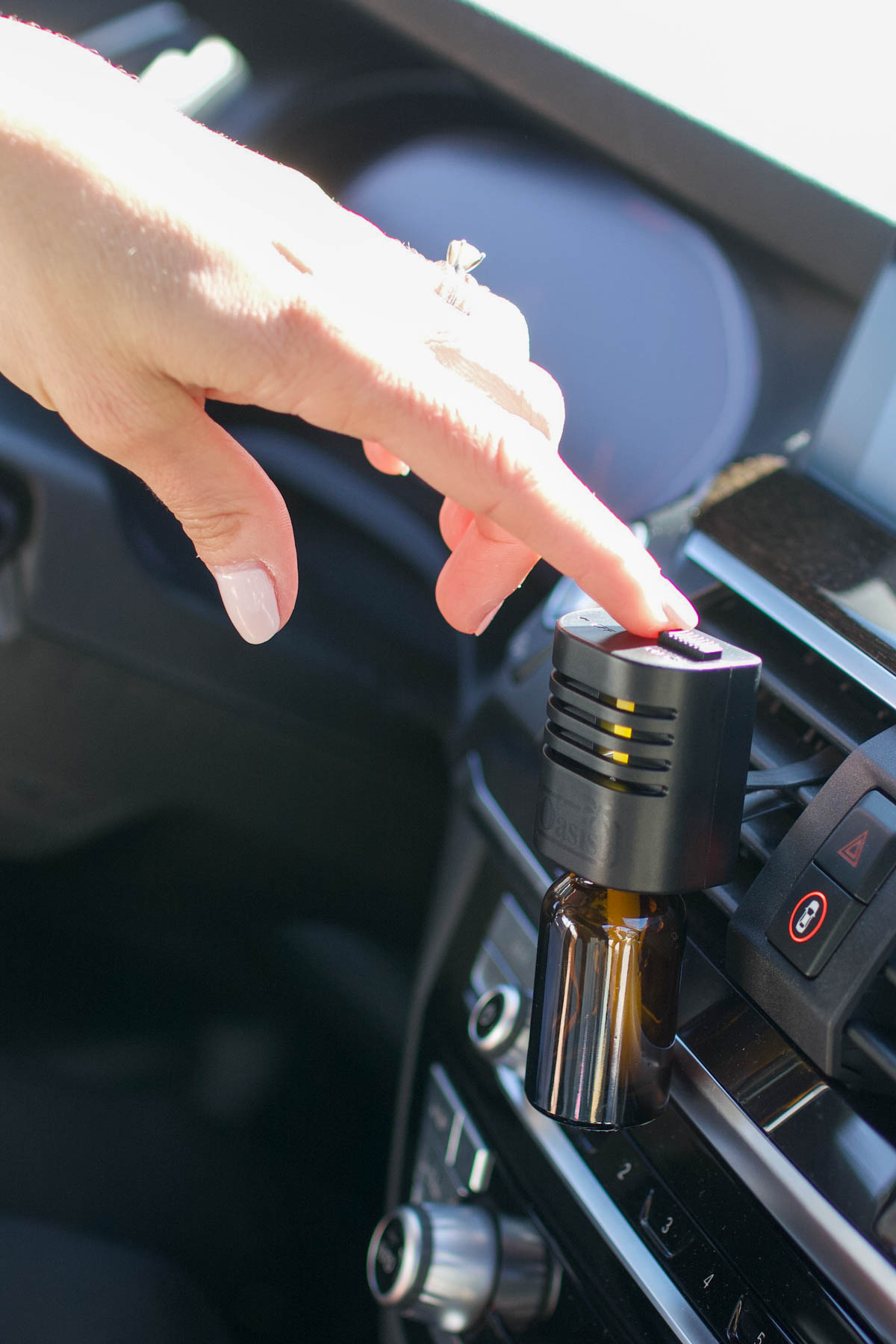 Woman touching her car vent diffuser.