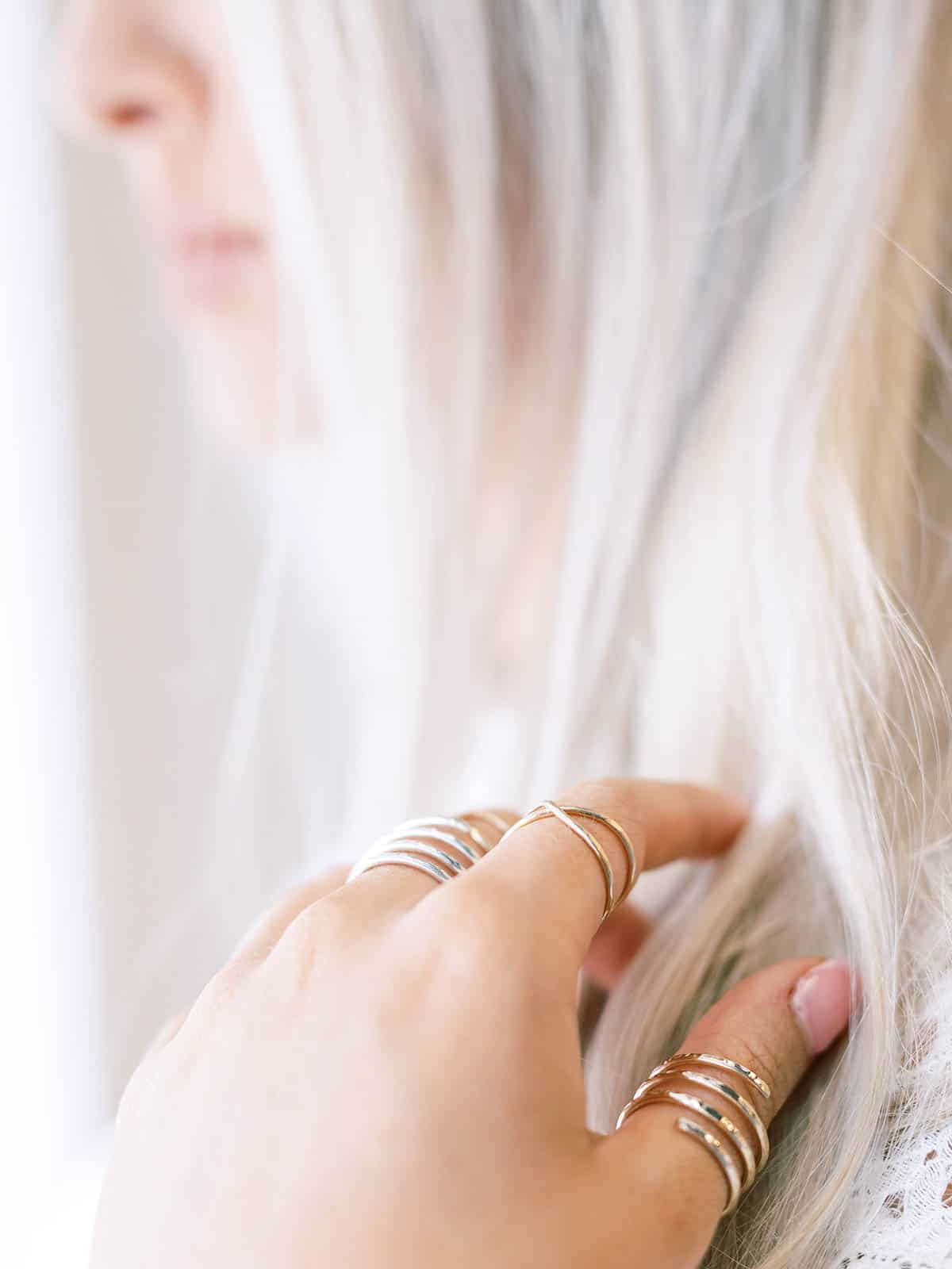 Blonde woman running her fingers through her hair.