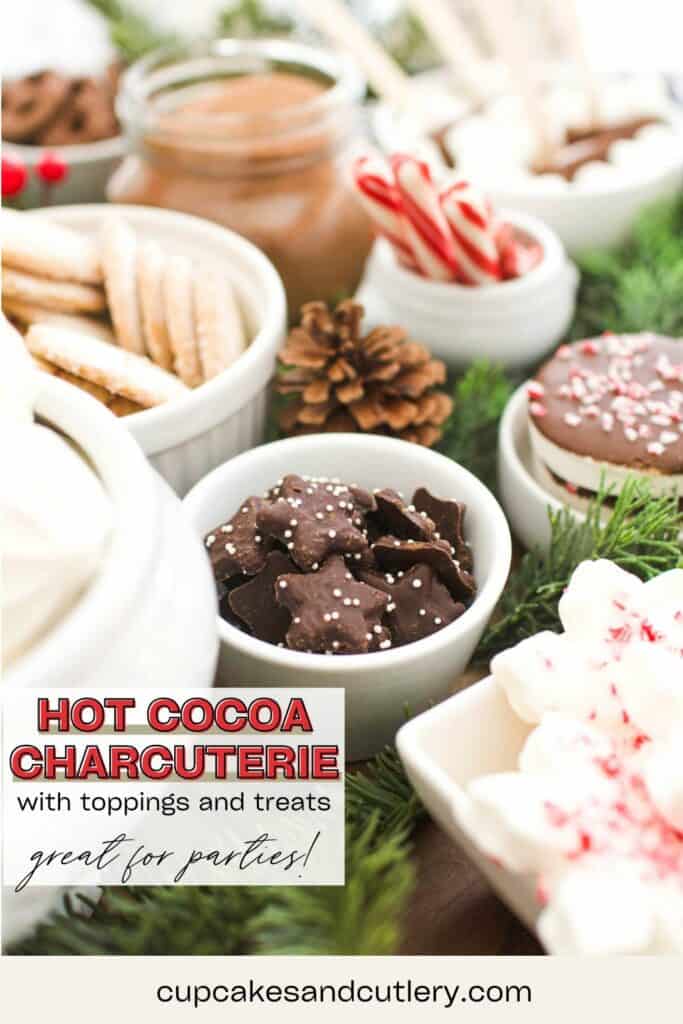 Text: Hot Cocoa Charcuterie with Toppings and treats, perfect for a party with a close up of some chocolate star cookies in a bowl on a hot chocolate platter.