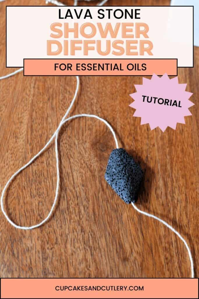 Text: Lava Stone Shower Diffuser for essential oils with a white string with a lava bead strung on it laying on a wooden tray.